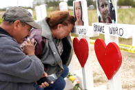 <p>NOV. 9, 2017 – Lorenzo Flores (L) and Terrie Smith react at a line of crosses in remembrance of those killed in the shooting at the First Baptist Church of Sutherland Springs, Texas. (Photo: Rick Wilking/Reuters) </p>