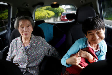Congenital Minamata disease patient Shinobu Sakamoto, 61, and her mother Fujie sit in a car as they head for a hospital in Minamata, Kumamoto Prefecture, Japan, September 14, 2017. REUTERS/Kim Kyung-Hoon