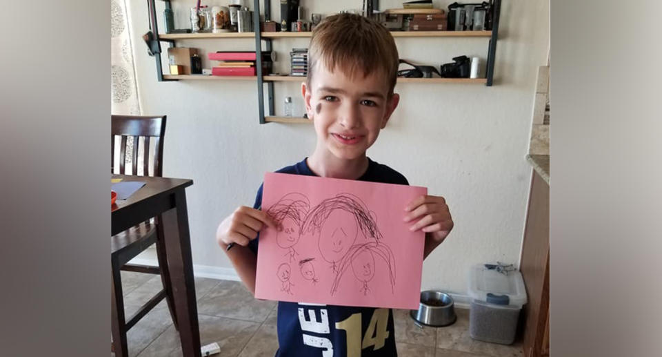 Mason holds a drawing of his family. Source: Facebook / Dalan Meredith Motz