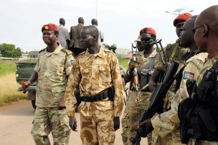 South Sudan National security members stand guard as they protect internally displaced people during a reallocation at the United Nations Mission in South Sudan (UNMISS) compound at the UN House in Jebel, in South Sudan's capital Juba, August 31, 2016. REUTERS/Jok Solomun