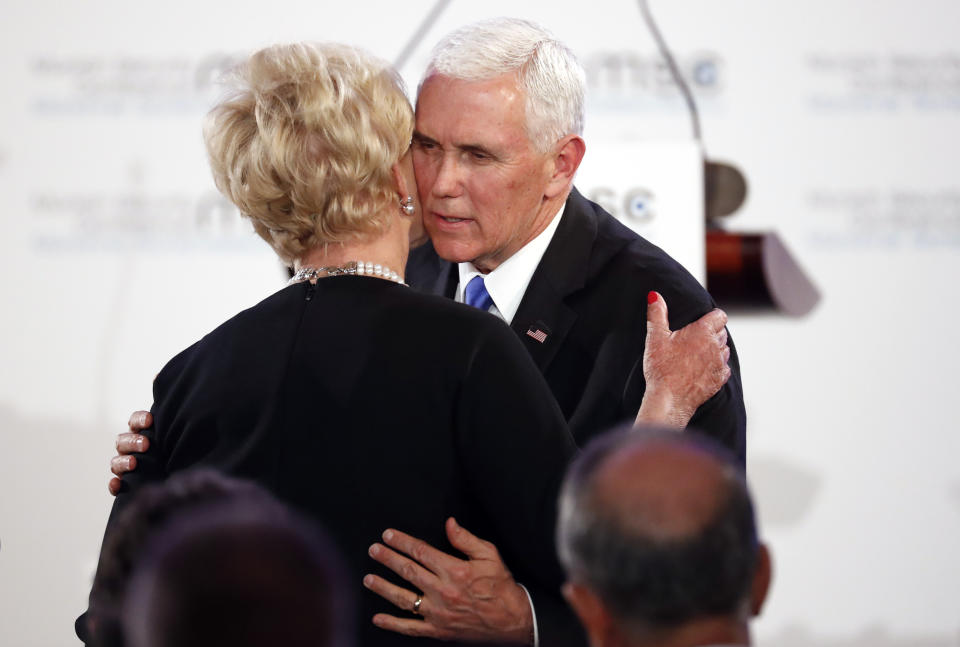 United States Vice President Mike Pence hugs Cindy McCain, widow of US Senator John McCain, after delivering his speech during the John McCain Dissertation Award Ceremony at the Bavarian State Parliament in Munich, Germany, Friday, Feb. 15, 2019. Pence arrived Thursday to attend the Munich Security Conference. (AP Photo/Matthias Schrader)