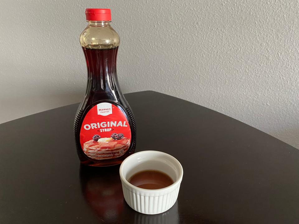 bottle of market pantry syrup from target next to a white ramekin filled with the syrup