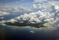 FILE – In this Nov. 14, 2005 file photo, clouds hang over the North Sentinel Island, in India's southeastern Andaman and Nicobar Islands. India used heat sensors on flights over hundreds of uninhabited Andaman Sea islands Friday, March 14, 2014, and will expand its search for the missing Malaysia Airlines jet farther west into the Bay of Bengal, officials said. The Indian-controlled archipelago that stretches south of Myanmar contains 572 islands covering an area of 720-by-52 kilometers. Only 37 are inhabited, with the rest covered in dense forests. (AP Photo/Gautam Singh, File)