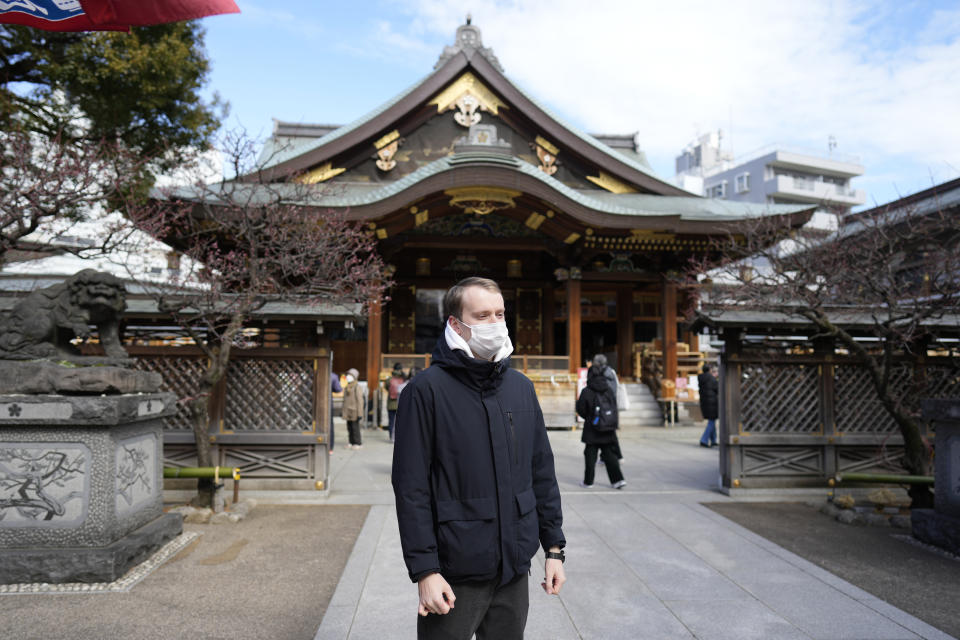 Ukrainian Dmytro Remez visits the Yushima Tenjin shrine on Feb. 15, 2023, in Tokyo, Japan. Remez, 24, a fledgling medical doctor studying at Juntendo University, is among the 2,291 Ukrainians who have moved to Japan since the war with Russia began a year ago. (AP Photo/Shuji Kajiyama)