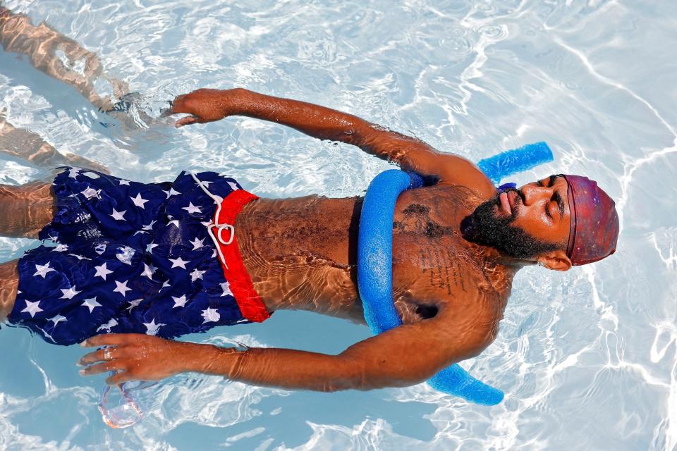 Yonny Hodges floats in the Lacy Park Pool, Friday, July 8, 2022 in Tulsa, Okla. A heat wave is forecast to continue scorching large parts of the southern and central U.S. this week.