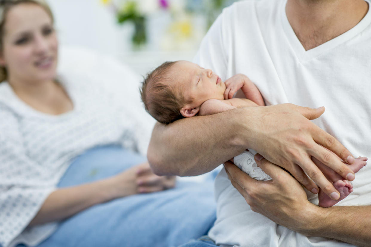 A mum has sparked a parenting debate about whether new dads should be able to stay in hospital after birth [Photo: Getty]