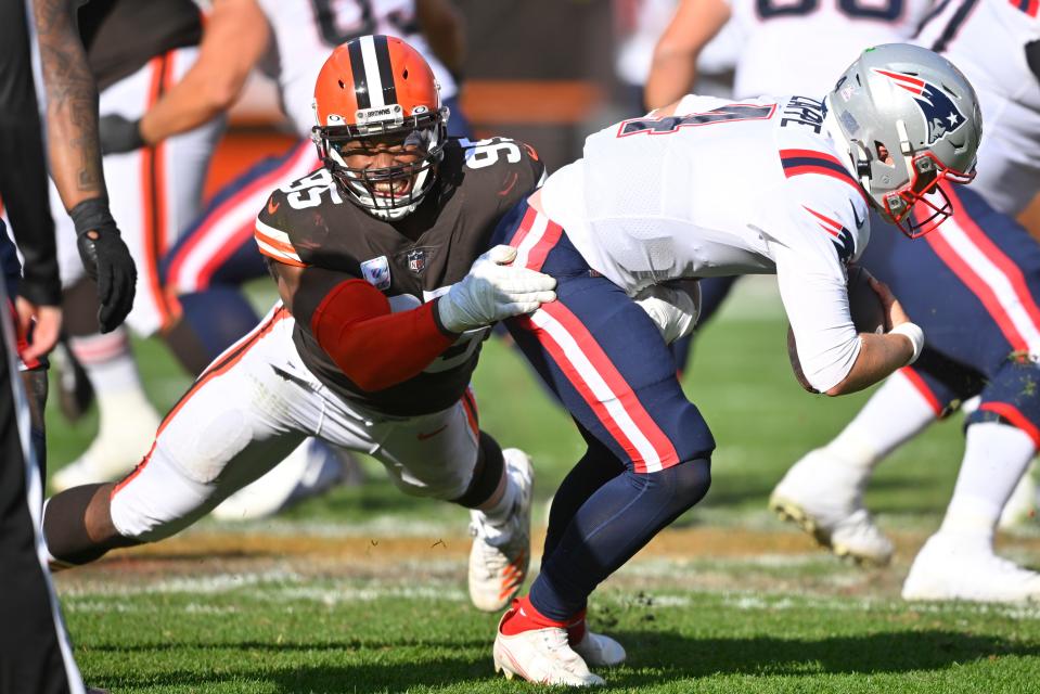Cleveland Browns defensive end Myles Garrett (95), left, sacks New England Patriots quarterback Bailey Zappe, right, during the second half an NFL football game, Sunday, Oct. 16, 2022, in Cleveland. (AP Photo/David Richard)