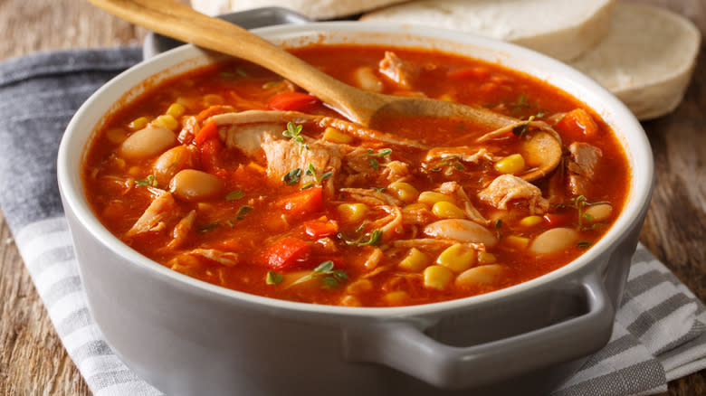 Chunky heart soup and wooden spoon