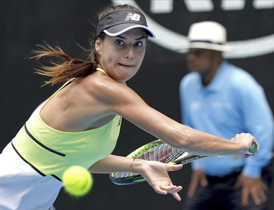 Romania's Sorana Cirstea makes a backhand return to Cori "Coco" Gauff of the U.S. during their second round singles match at the Australian Open tennis championship in Melbourne, Australia, Wednesday, Jan. 22, 2020. (AP Photo/Lee Jin-man)