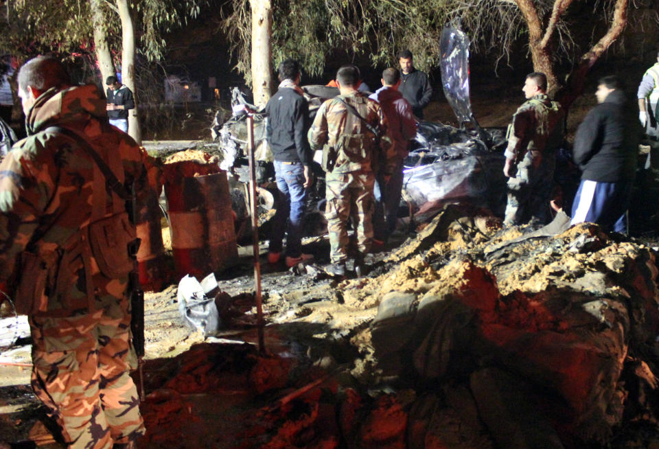 Lebanese army and citizens gather at the site of an explosion, in the predominately Shiite town of Hermel, about 10 miles (16 kilometers) from the Syrian border in northeast Lebanon, Saturday, Feb. 22, 2014. A suicide attacker blew himself up at an army checkpoint after troops tried to search his car Saturday, killing and wounding a number of people including soldiers in the latest blast linked to Syria's civil war, a senior military official and the state news agency said. (AP Photo)