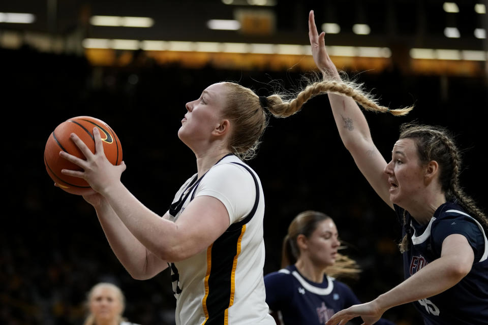 Iowa forward Addison O'Grady drives to the basket past Fairleigh Dickinson forward Lilly Parke, right, during the second half of an NCAA college basketball game, Monday, Nov. 6, 2023, in Iowa City, Iowa. (AP Photo/Charlie Neibergall)