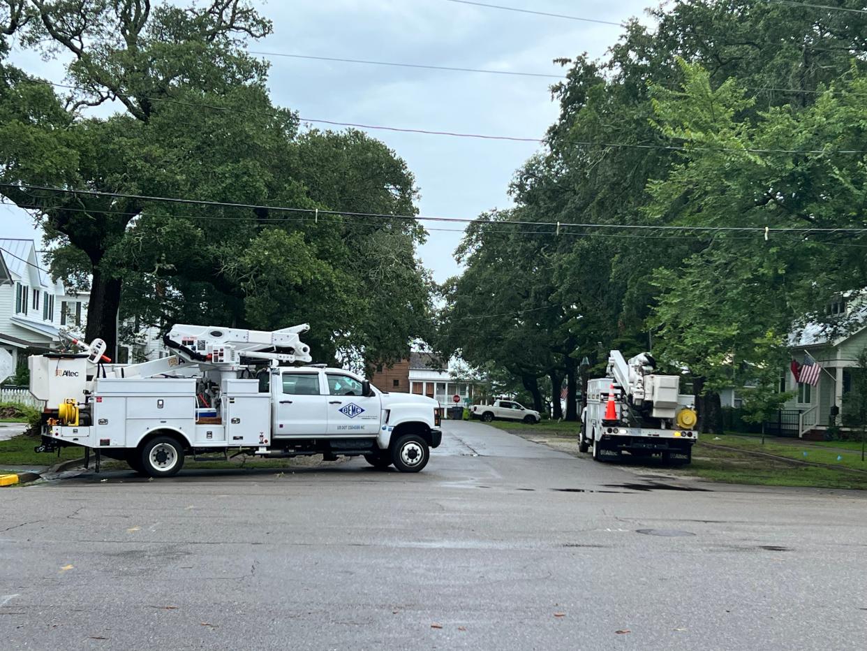 Crews with Brunswick Electric Membership Company work to address a power outage on East Moore Street in Southport ahead of Tropical Storm Debby on Tuesday, Aug. 6, 2024.