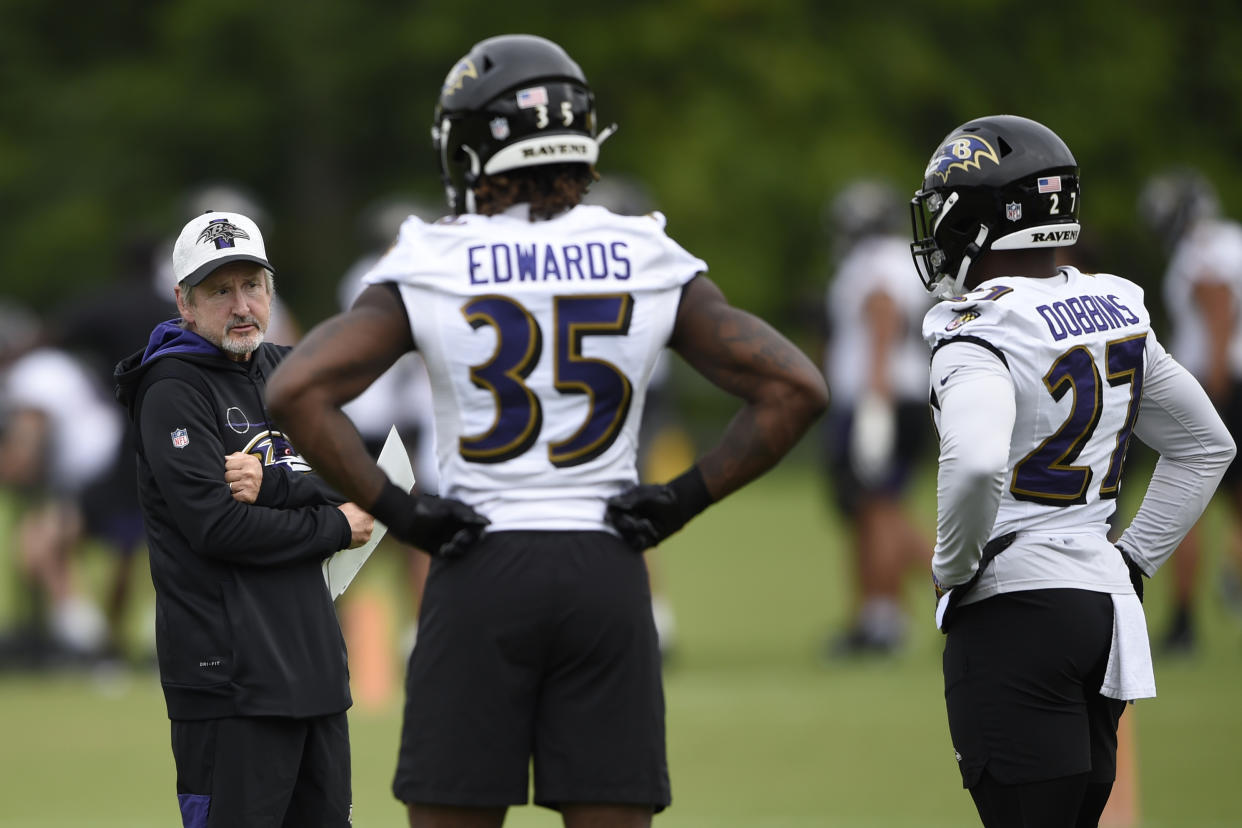 Baltimore Ravens running back coach Craig Ver Steeg, left, talks with running backs Gus Edwards and J.K. Dobbins during an NFL football practice, Monday, Aug. 16, 2021, in Owings Mills, Md.(AP Photo/Gail Burton)