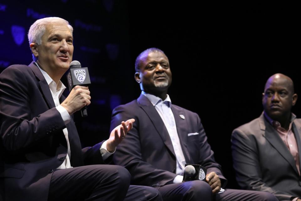 Pac-12 Commissioner George Kliavkoff, from left, answers a question next toMerton Hanks and Bernard Muir.