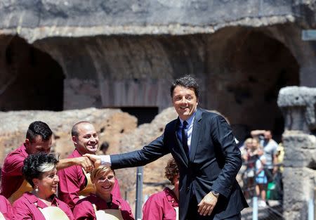 Italy's Prime Minister Matteo Renzi (R) is greeted during a news conference about the latest stage of restoration of the Colosseum by luxury goods firm Tod's in Rome, Italy, July 1, 2016. REUTERS/Alessandro Bianchi