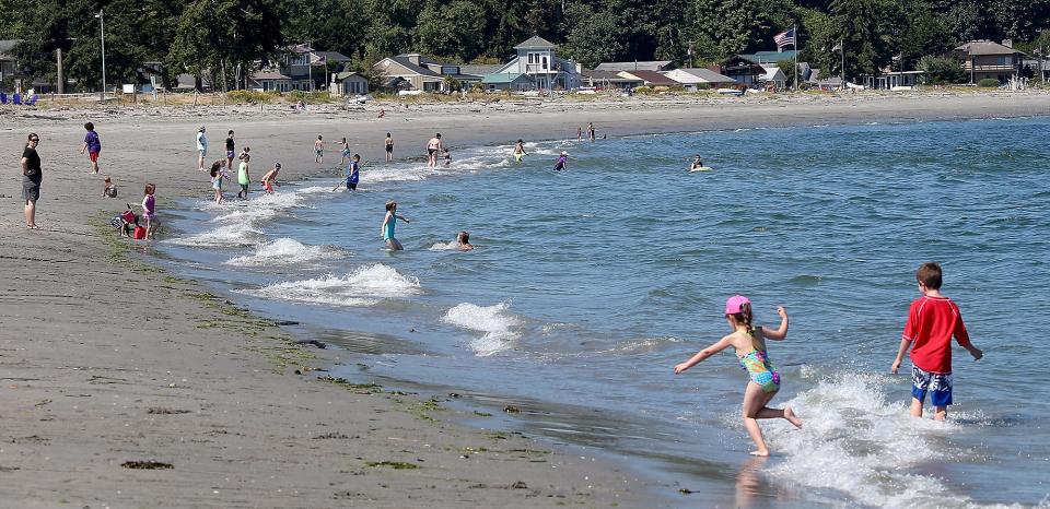 Youngsters dot the shoreline as the waves hit the beach at Point No Point in Hansville on Tuesday, July 24, 2018.