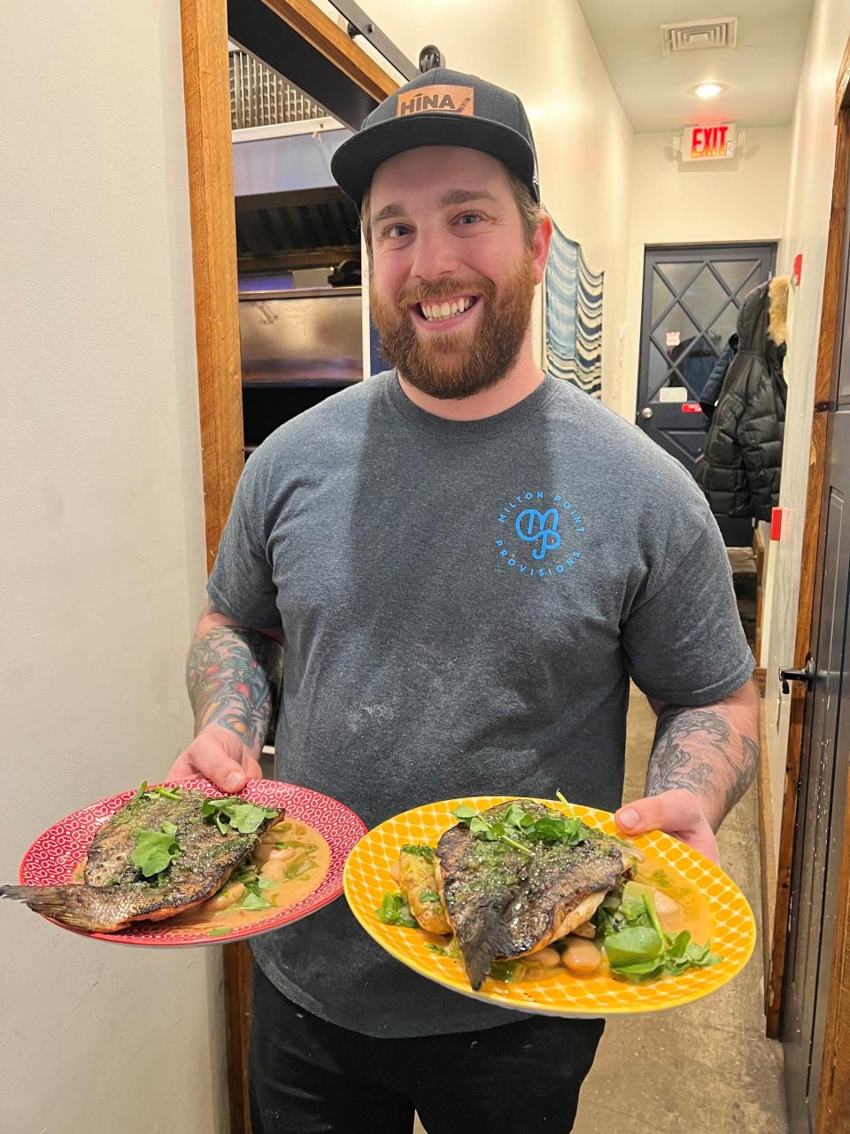 Chef Evan Kalogiannis with wood-fired branzino at Milton Point Provisions in Rye. The branzino ranks among Food Reporter Jeanne Muchnick's top dishes of 2022. Photographed Dec. 14, 2022.