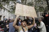 In this Sept. 17, 2011 file photo, a woman in the crowd displays a sign as demonstrators affiliated with the Occupy Wall Street movement gather to call for the occupation of Wall Street in New York. Monday, Sept. 17, 2012 marks the one-year anniversary of the Occupy Wall Street movement. (AP Photo/Frank Franklin II, File)