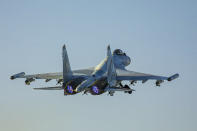 In this photo released by Russian Defense Ministry Press Service on Friday, June 25, 2021, a Su-35 fighter jet of the Russian air force takes off from the Hemeimeem air base in Syria. The Russian military on Friday launched sweeping maneuvers in the Mediterranean Sea featuring warplanes capable of carrying hypersonic missiles, a show of force amid a surge in tensions following an incident with a British destroyer in the Black Sea. (Russian Defense Ministry Press Service via AP)