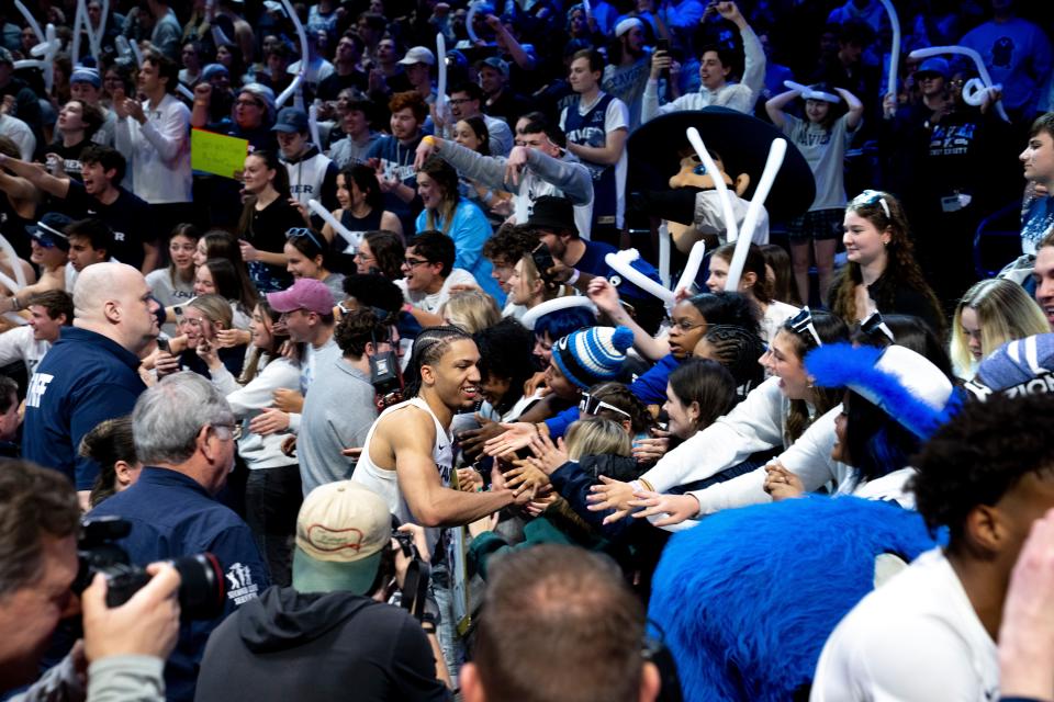 Xavier Musketeers guard Desmond Claude (1) celebrates with fans after the NCAA basketball game between Xavier Musketeers and Villanova Wildcats at the Cintas Center in Cincinnati on Wednesday, Feb. 7, 2024. Xavier Musketeers defeated Villanova Wildcats 56-53.