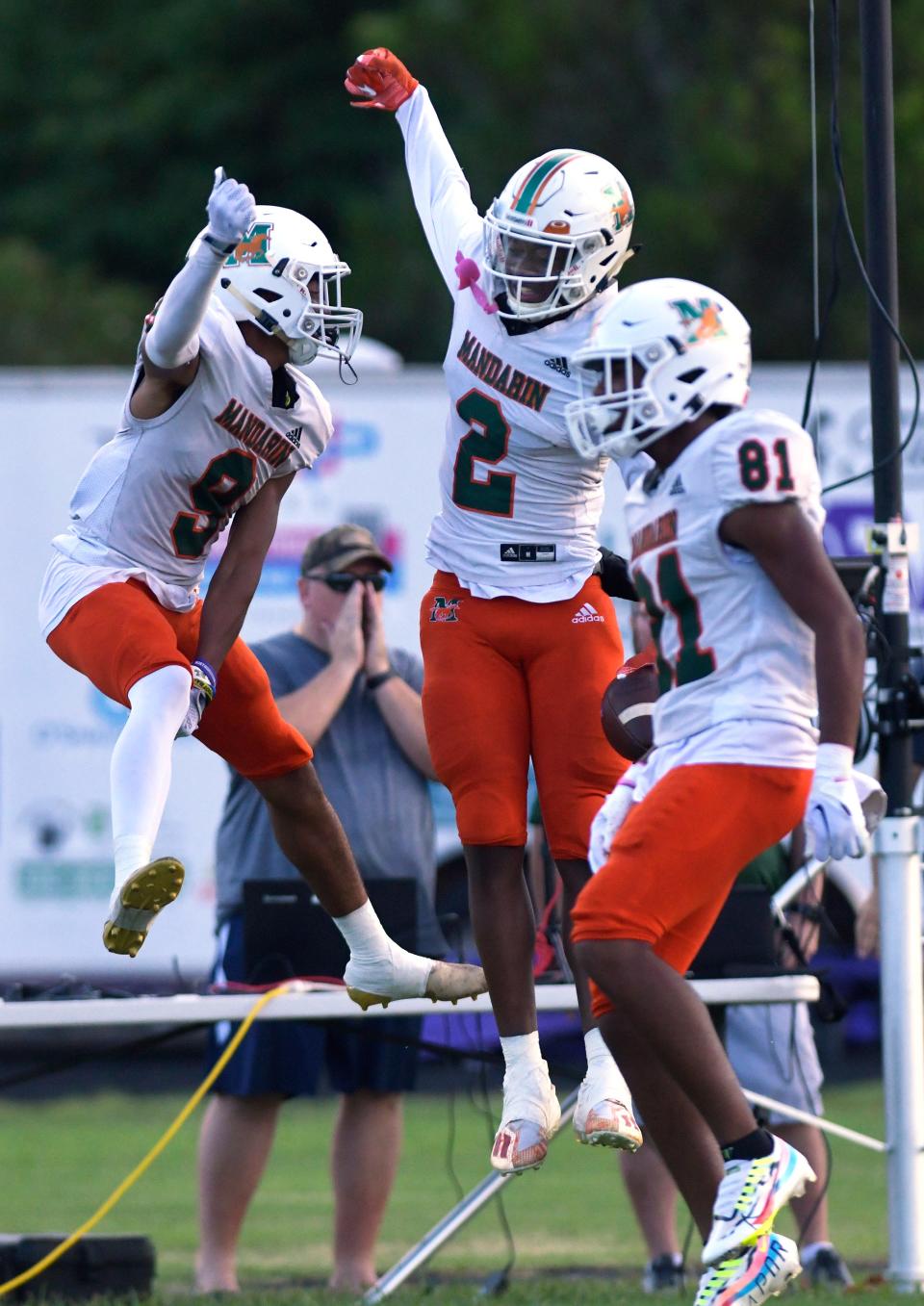 Mandarin's Jaime Ffrench (2) celebrates with teammates Josiah Watkins (81) and Kieren Jackson (9) after Ffrench took a pass for a 65 yard touchdown in early first-quarter action against Fletcher on Aug. 26.