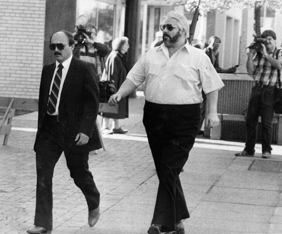 Then-Erie police Detective Sgt. Dominick DiPaolo, left, leads informant Sam "Fat Sam" Esper to the federal courthouse in Erie to appear before a federal grand jury on May 24, 1984. The grand jury returned no indictments in the contract killing of Erie bookmaker Frank "Bolo" Dovishaw in January 1983 and the shooting death of Erie police Cpl. Robert Owen in December 1980, though those cases were eventually prosecuted in Erie County Common Pleas Court. Esper later entered the federal witness protection program.