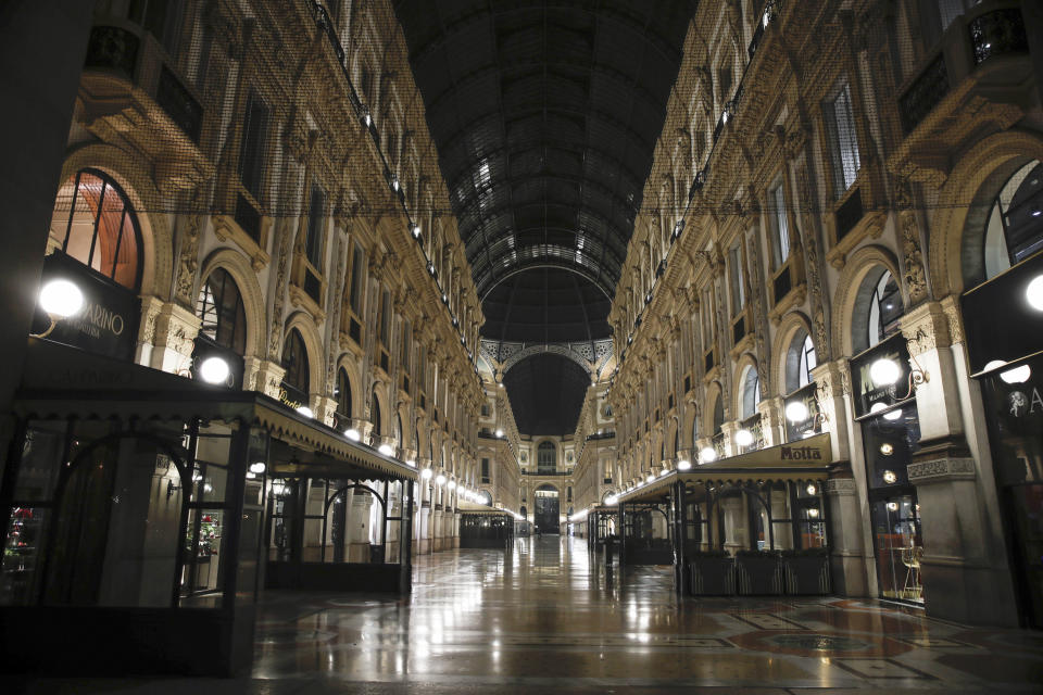 The Vittorio Emanuele II arcarde is deserted, in Milan, northern Italy, early Sunday, Oct. 25, 2020. Since the 11 p.m.-5 a.m. curfew took effect last Thursday, people can only move around during those hours for reasons of work, health or necessity. (AP Photo/Luca Bruno)