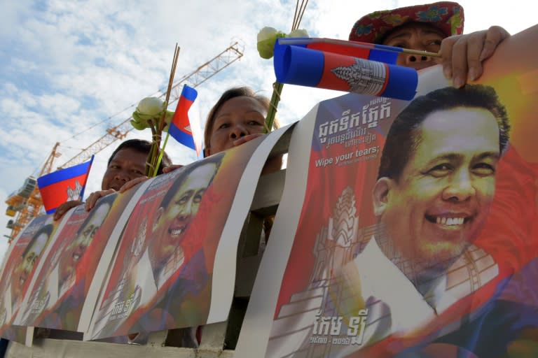 Cambodians hold images of Kem Ley during a 2016 funeral procession for the pro-democracy campaigner in Phnom Penh