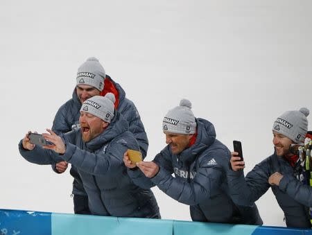 Nordic Combined Events - Pyeongchang 2018 Winter Olympics - Men's Individual 10 km Final - Alpensia Cross-Country Skiing Centre - Pyeongchang, South Korea - February 20, 2018 - Coaches of the German team take pictures during the victory ceremony. REUTERS/Dominic Ebenbichler