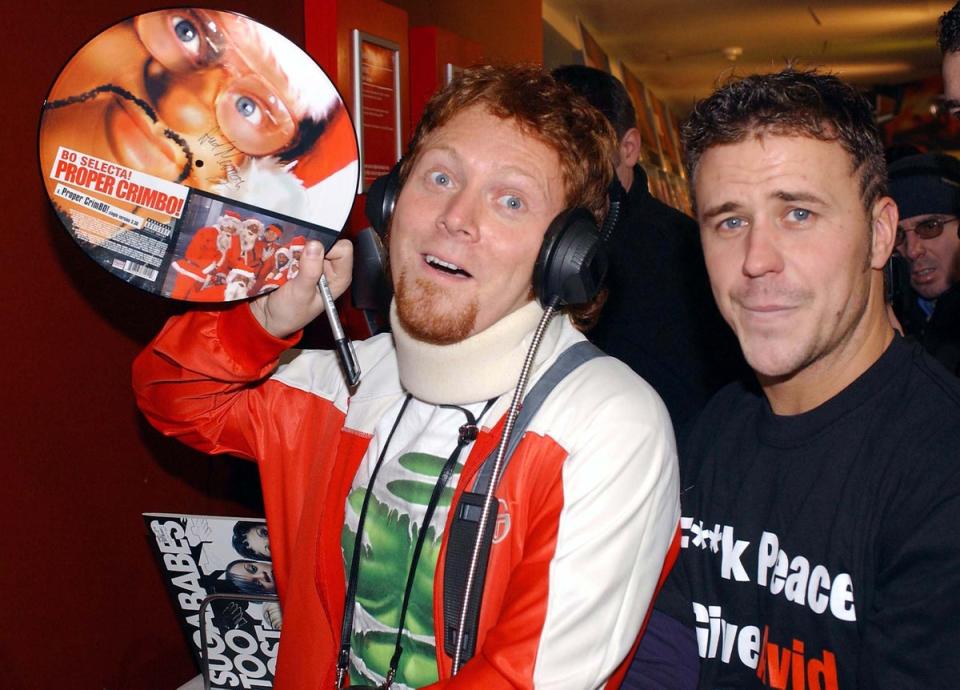Francis, holding an image of David’s Bo’ Selecta! character alongside TV presenter Craig Phillips in 2003, has apologised to Craig David for the portrayal of him (Getty Images)