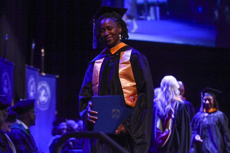 Natasha Le Gendre walks off the stage after earning her Master of Science in Nursing degree from Keiser University during the college's commencement ceremony at Westside Church on Friday, June 2, 2023, in Fort Pierce.