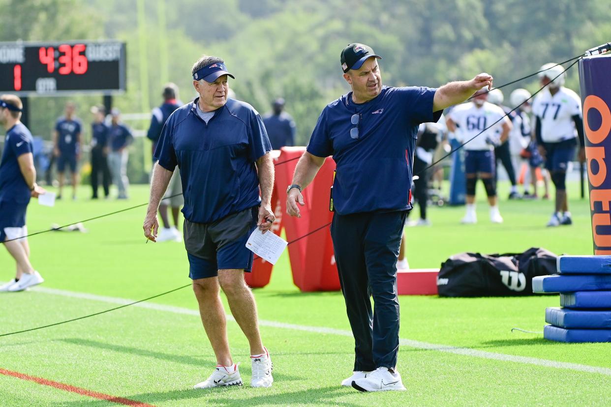 Patriots offensive coordinator Bill O'Brien points out something to head coach Bill Belichick during training camp on Wednesday in Foxboro.