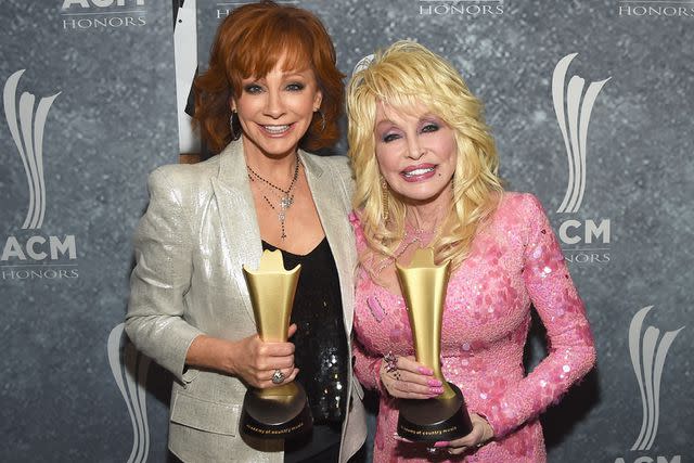 <p>Rick Diamond/Getty</p> Reba McEntire and Dolly Parton attend the 11th Annual ACM Honors in Nashville, Tennessee on August 23, 2017.