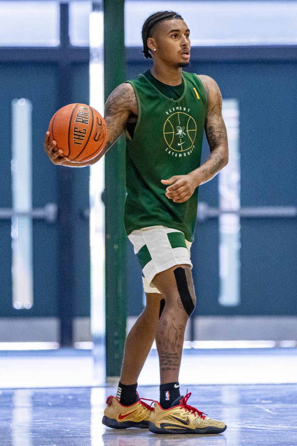 Senior Aaron Deloney looks to pass during a UVM men's basketball summer practice earlier this month at Patrick Gym.