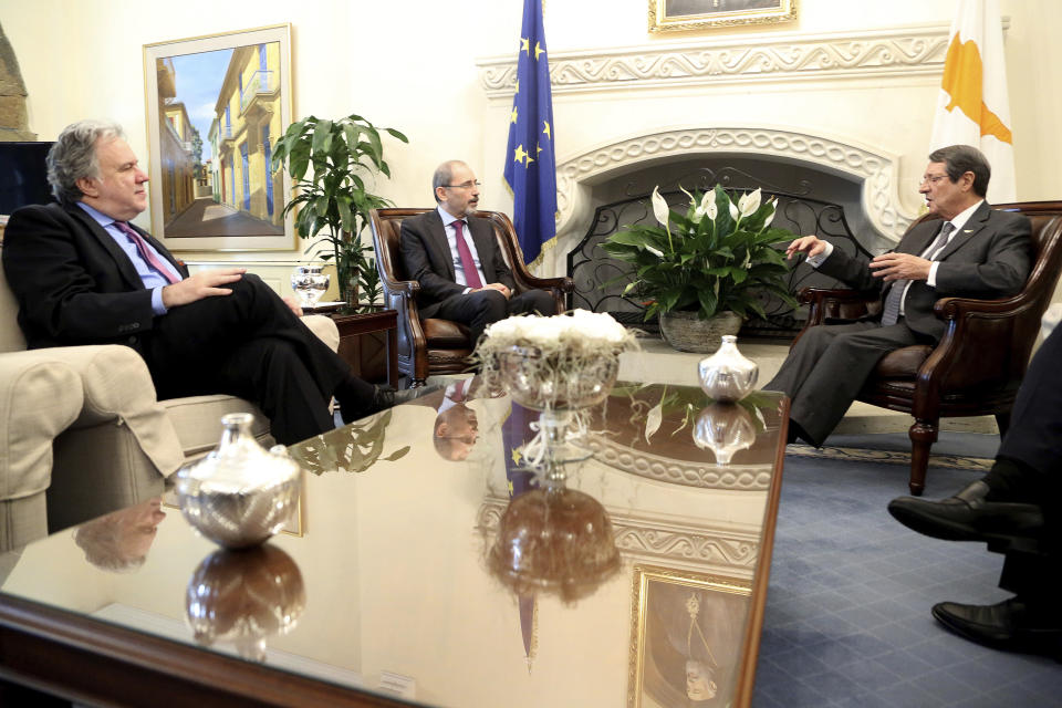 Cyprus' president Nicos Anastasiades, right, talks with Foreign minister of Jordan Ayman Safadi, centre, and the Greek Alternate Minister of Foreign Affairs Georgios Katrougalos, left, during their meeting at the presidential palace in Nicosia, Cyprus, Wednesday, Dec. 19, 2018. The ministers are meeting in the Cypriot capital to explore ways of strengthening ties on fields as varied as education and entrepreneurship. (AP Photo/Petros Karadjias)