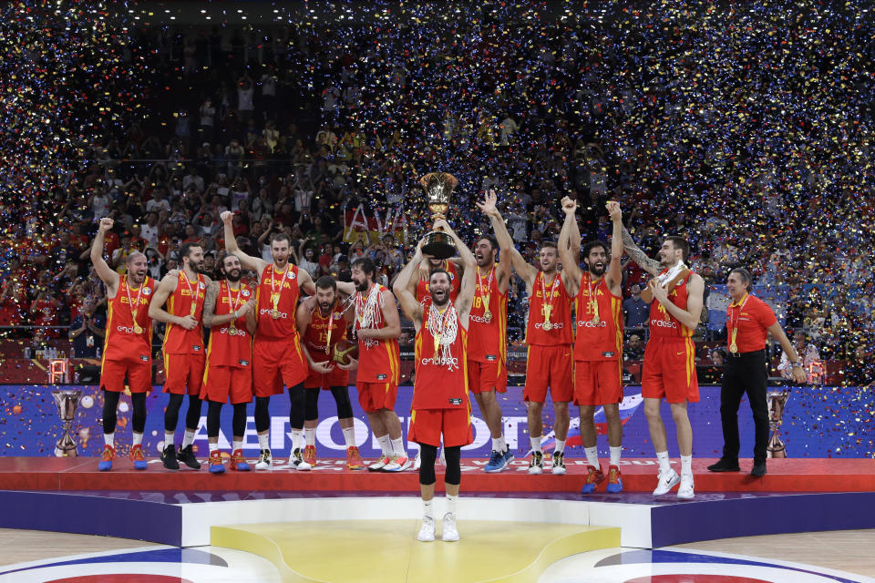 Members of Spain's team celebrate with the Naismith Trophy after they beat Argentina in their first-place match in the FIBA Basketball World Cup at the Cadillac Arena in Beijing, Sunday, Sept. 15, 2019. (AP Photo/Mark Schiefelbein)