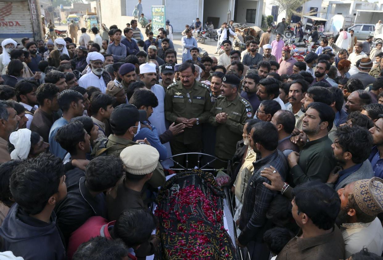 People gather around the body of a man who was killed when an enraged mob stoned him to death for allegedly desecrating the Quran, in eastern Pakistan in February 2022. <a href="https://newsroom.ap.org/detail/PakistanBlasphemy/627a5c4fb72347f4b181cbe63397b031/photo?Query=pakistan%20blasphemy%202022&mediaType=photo&sortBy=&dateRange=Anytime&totalCount=15&currentItemNo=13" rel="nofollow noopener" target="_blank" data-ylk="slk:AP Photo/Asim Tanveer;elm:context_link;itc:0;sec:content-canvas" class="link ">AP Photo/Asim Tanveer</a>