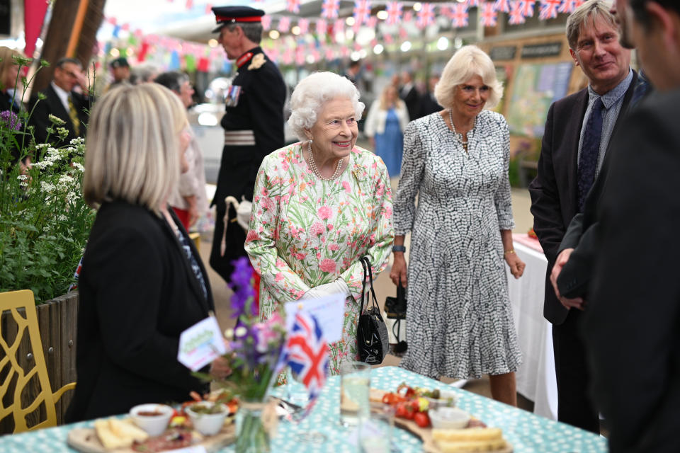 ST AUSTELL, ENGLAND - JUNE 11: Queen Elizabeth II (C) smiles as she meets people from communities across Cornwall at an event in celebration of The Big Lunch initiative at The Eden Project during the G7 Summit on June 11, 2021 in St Austell, Cornwall, England. UK Prime Minister, Boris Johnson, hosts leaders from the USA, Japan, Germany, France, Italy and Canada at the G7 Summit. This year the UK has invited India, South Africa, and South Korea to attend the Leaders' Summit as guest countries as well as the EU. (Photo by Oli Scarff - WPA Pool / Getty Images)