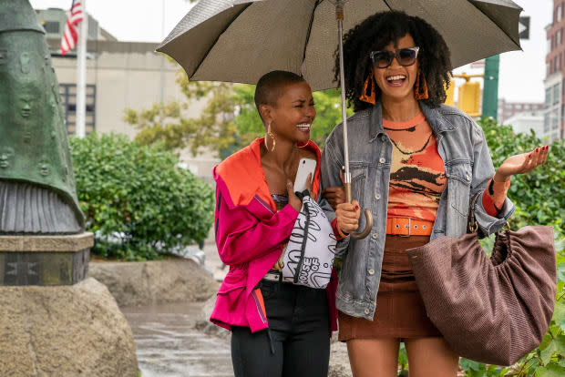 Ella, in a Dries Van Noten anorak, over a Biggie Smalls T-shirt corset from Patricia Field's vintage line, walking with Sondi (Corbin Reid) and <em>carrying a House of Field belt bag. </em>