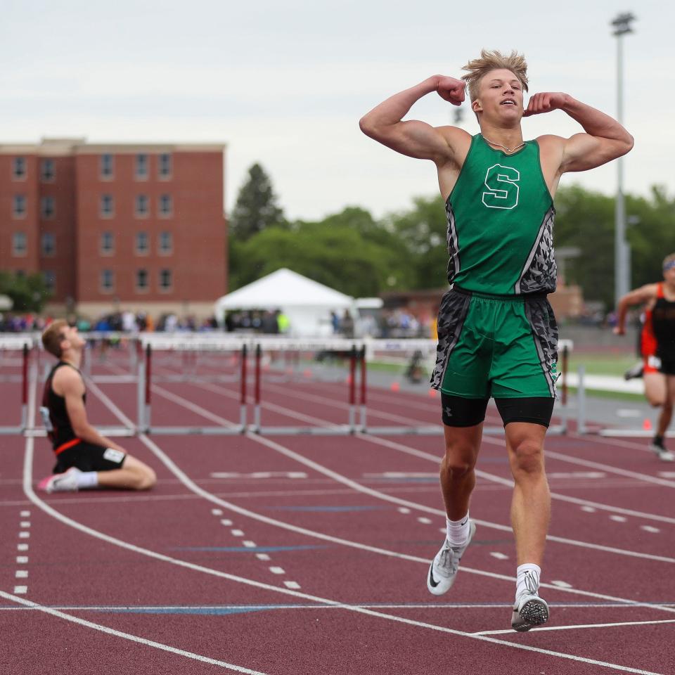 Shiocton's Cade Stingle flexes after beating Reedsville's Brennen Dvorachek (kneeling) in the Division 3 boys 300-meter hurdles final during the WIAA state track and field meet June 4, 2022, at Veterans Memorial Stadium Complex in La Crosse.