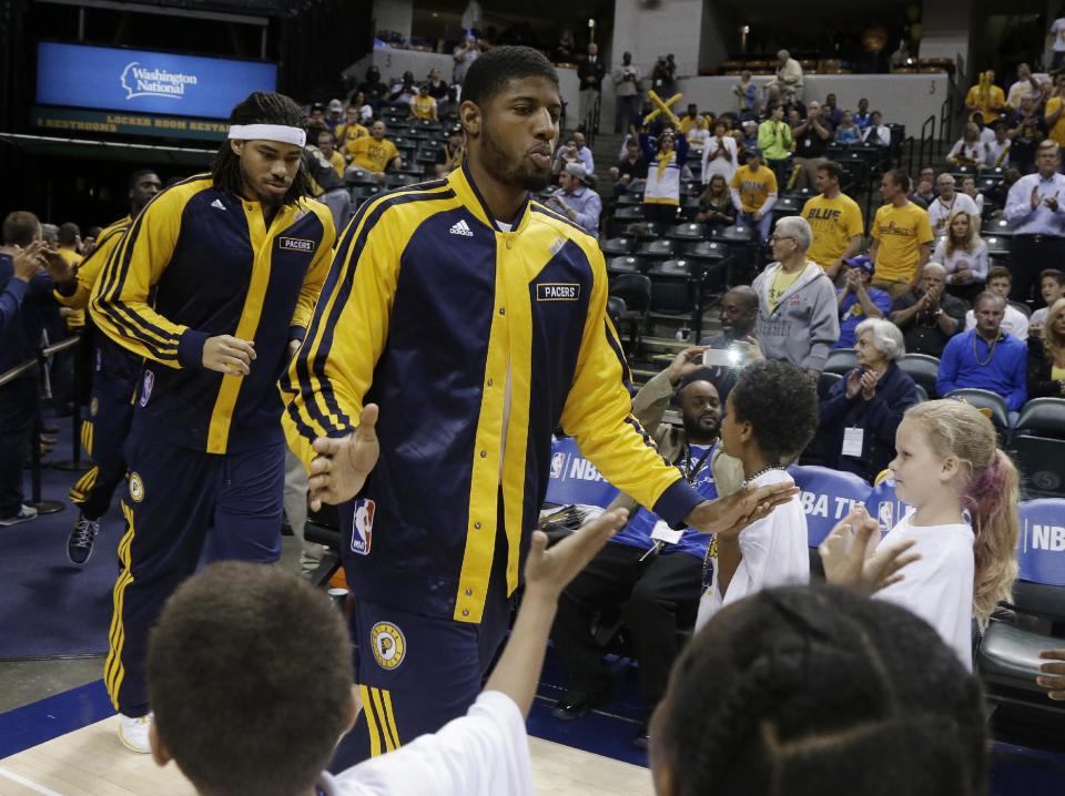 Indiana Pacers' Paul George runs onto the court for warm-ups at Game 5 of the Pacers' opening-round NBA basketball playoff series against the Atlanta Hawks, Monday, April 28, 2014, in Indianapolis. (AP Photo/Darron Cummings)