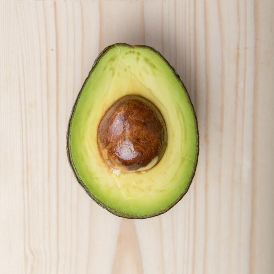 avocado on wood table,healthy food concept,romania