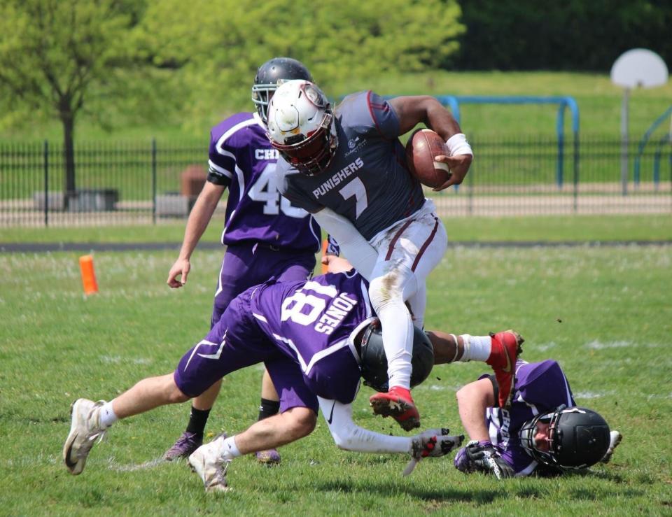 Peoria Punishers running back Quinton Fonville breaks tackles during a Mid-American 8-man Football League game in 2023.