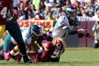 <p>Philadelphia Eagles quarterback Carson Wentz (11) is sacked by Washington Redskins linebacker Ryan Kerrigan (91) in the first quarter at FedEx Field. Mandatory Credit: Geoff Burke-USA TODAY Sports </p>