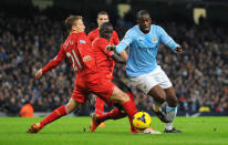 Manchester City's Yaya Toure (right) battles for the ball with Liverpool's Mamadou Sakho and Lucas Leiva (left), during the Barclays Premier League match at the Etihad Stadium, Manchester.