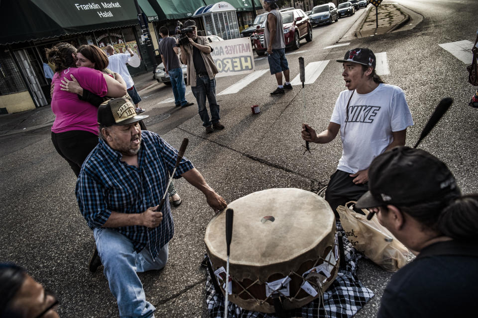 Demonstrators form a drum circle during a vigil for William "Billy" Hughes in front of the American Indian Center on Monday, Aug. 6, 2018 in St. Paul, Minn. The Bureau of Criminal Apprehension said in a statement Tuesday, Aug. 7, that William James Hughes, 43, died of multiple gunshot wounds early Sunday after officers responded to a 911 call of multiple shots fired on the upper floor of the apartment building where he lived. (Richard Tsong-Taatarii/Star Tribune via AP)