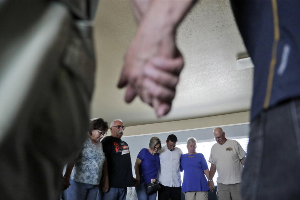 Congregants pray during a service inside the Christian Fellowship of Trona in the aftermath of an earthquake Sunday, July 7, 2019, in Trona, Calif. (AP Photo/Marcio Jose Sanchez)