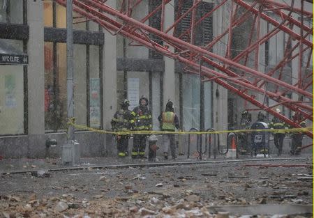 Emergency crews survey a massive construction crane collapse on a street in downtown Manhattan in New York February 5, 2016. REUTERS/Brendan McDermid