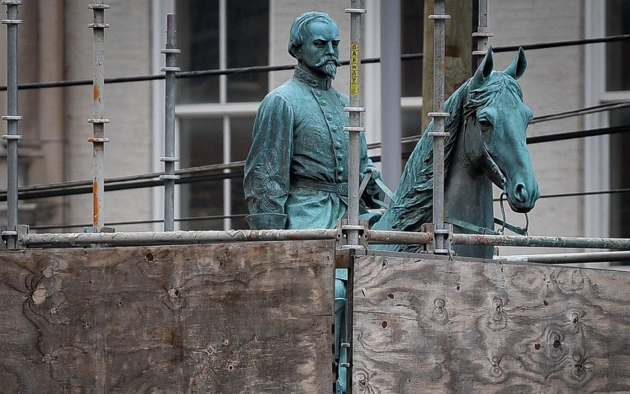 A monument to confederate General John Hunt Morgan stands encased in a protective scaffolding because of local construction, outside the Historic Lexington Courthouse in Lexington - REUTERS