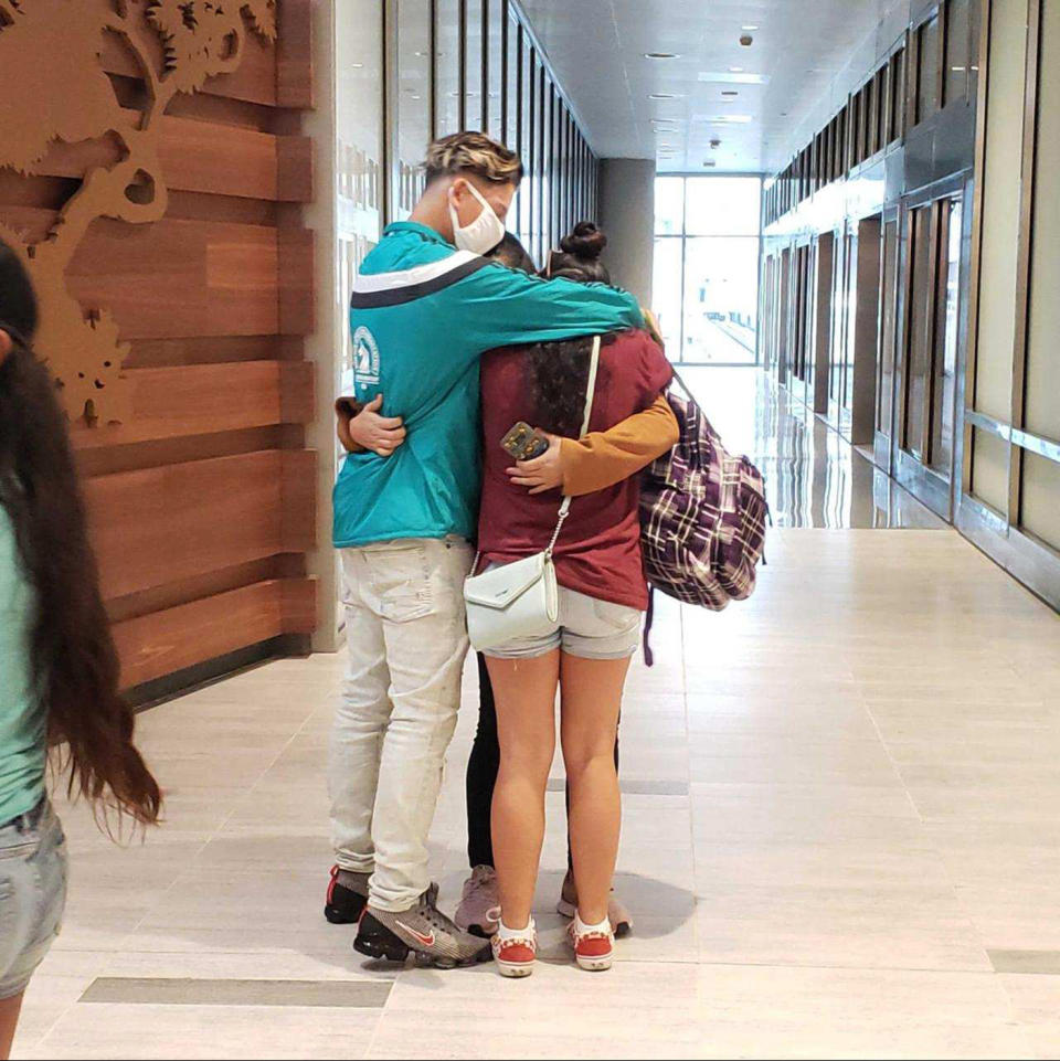 Yudissa hugs her son and daughter on Sunday in the airport in Tampa, Fla., where they reunited after years spent apart. (Miles4Migrants)